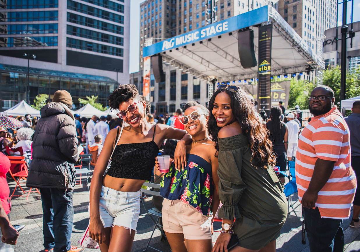 three women smiling at Fountain Square