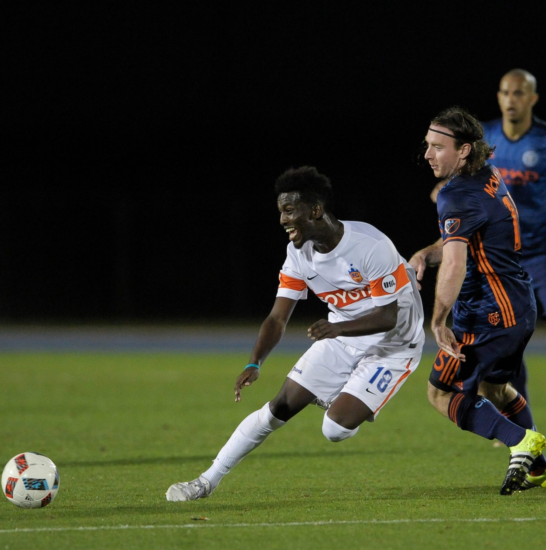 FC Cincinnati player kicking the soccer ball