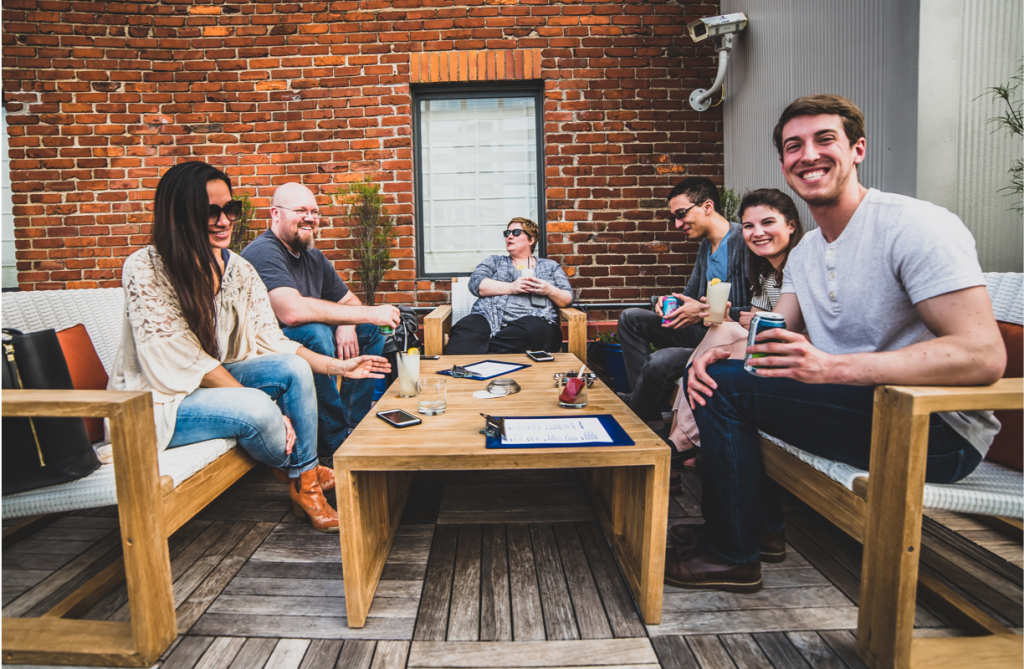 Cincinnati young adults sitting on rooftop bar is one thing that makes cincinnati a good place to live