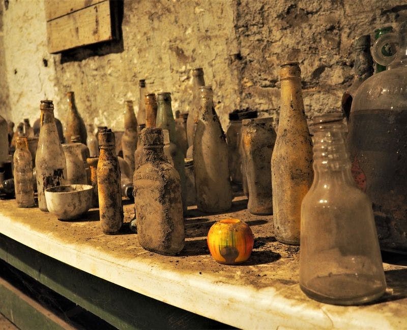old dusty glassware in the john kauffman brewing company underground vaults
