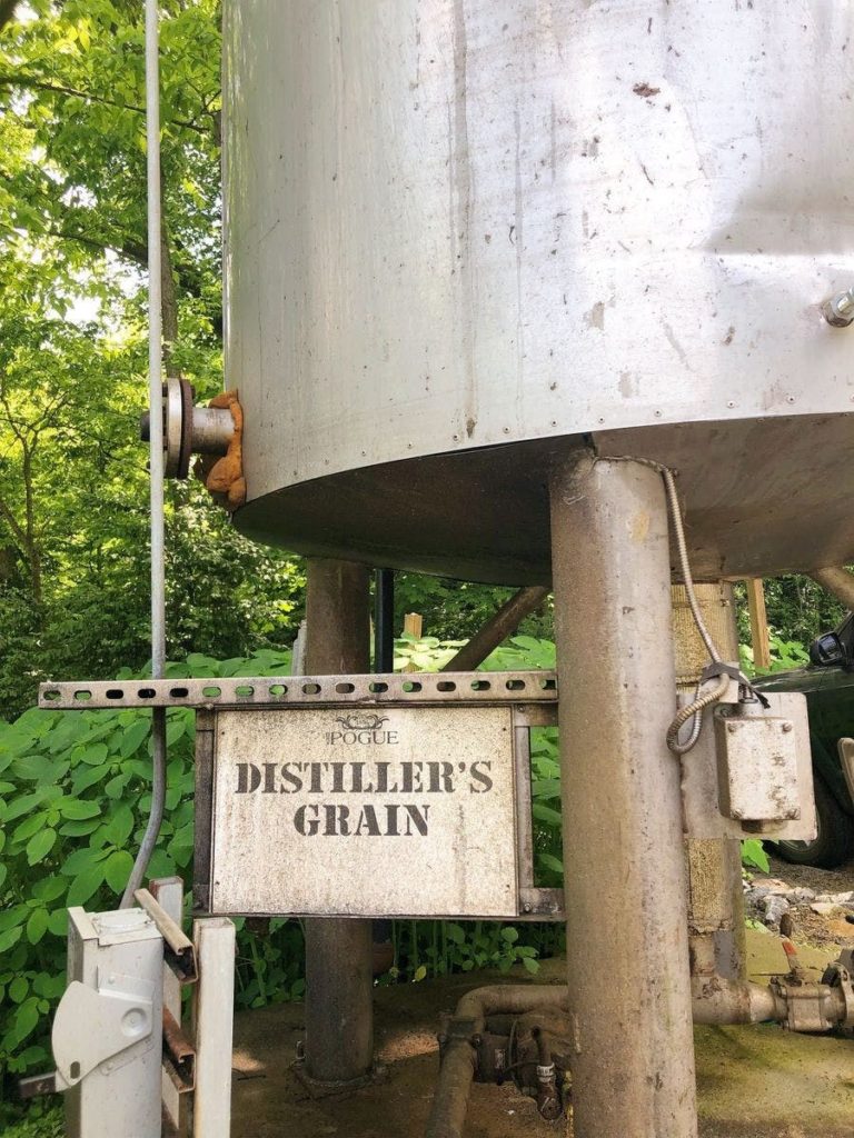 sign saying distiller's grain on side of grain bin