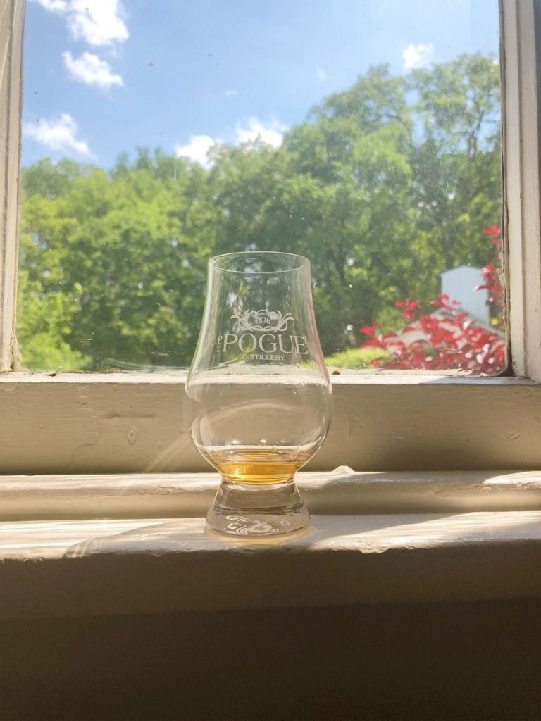 cincinnati bourbon lovers enjoy a glass with a little bourbon remaining sitting on a windowsill