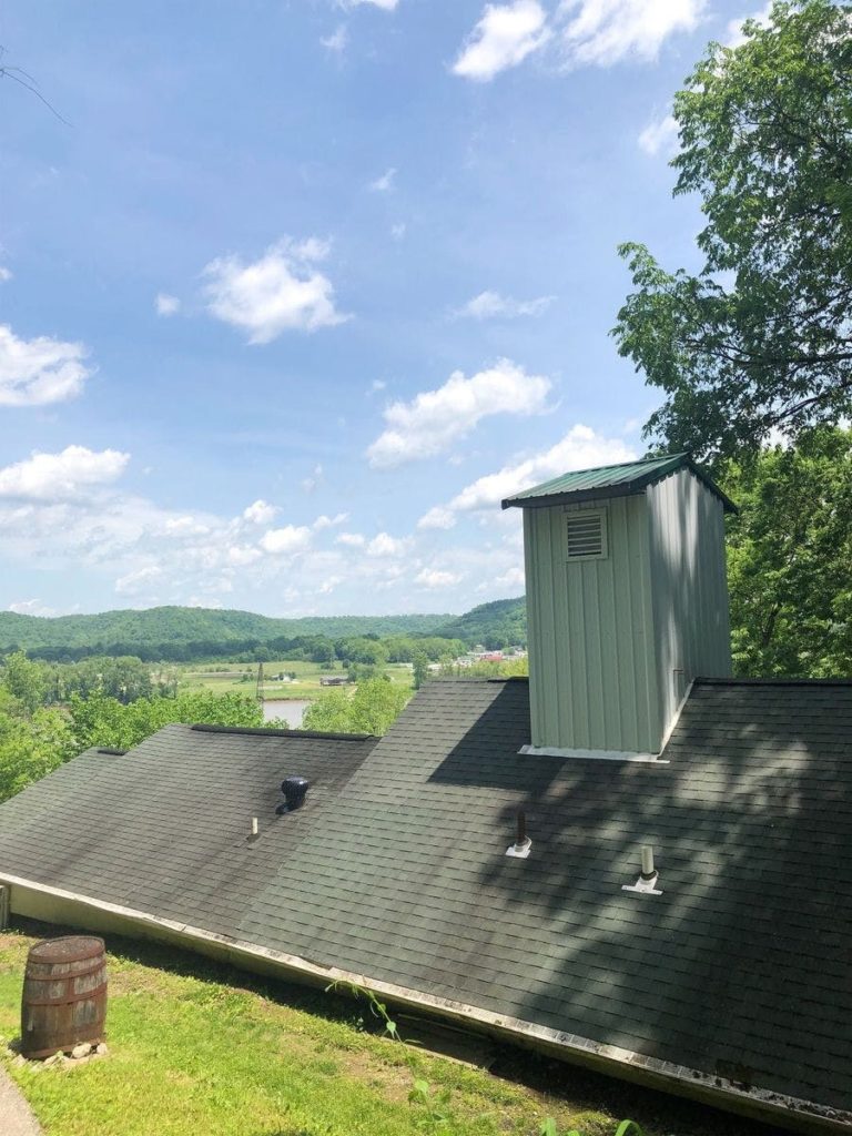 building with mossy green roof of distilling equipment for cincinnati borbon