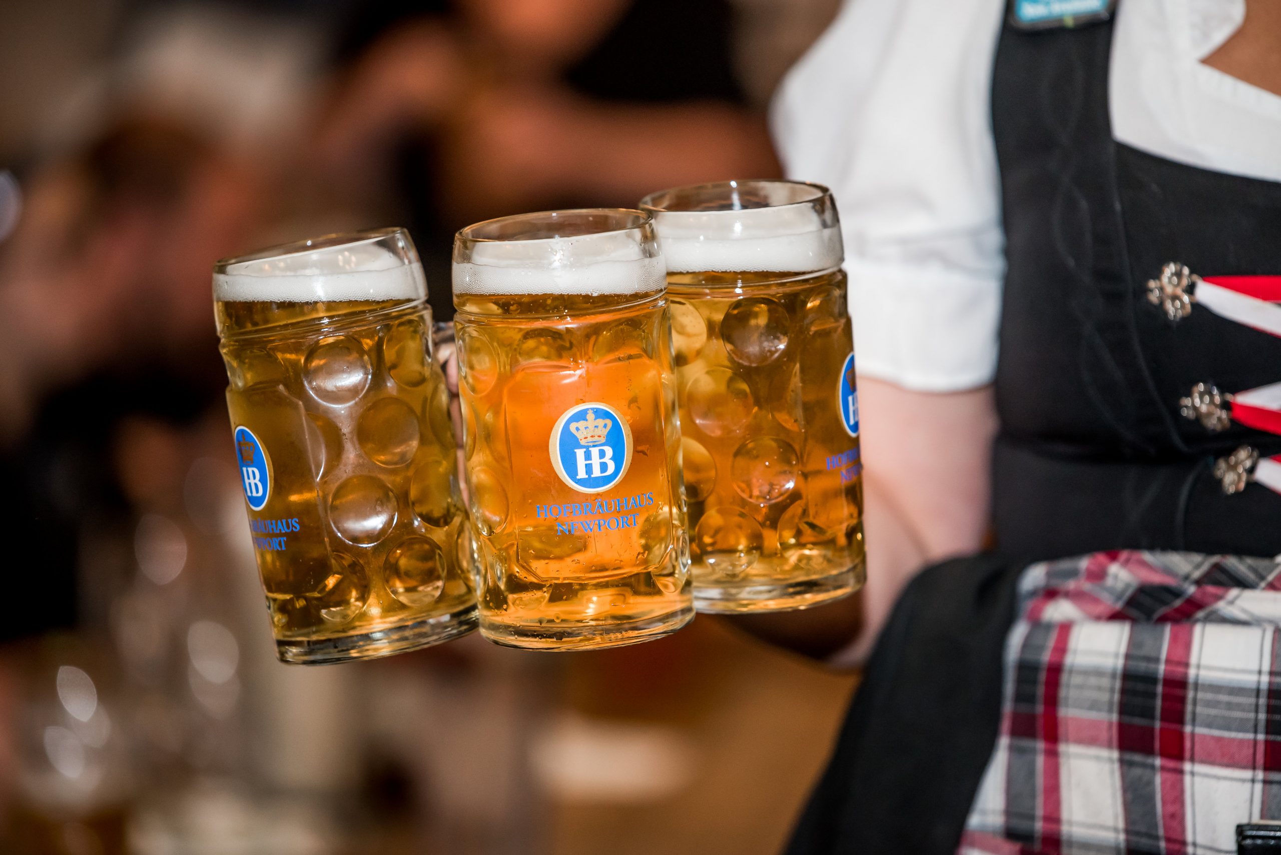 3 Authentic German Beer Steins carried by waitress in one of the top Cincinnati breweries
