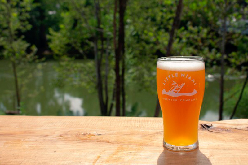 little miami glass of beer with river in background