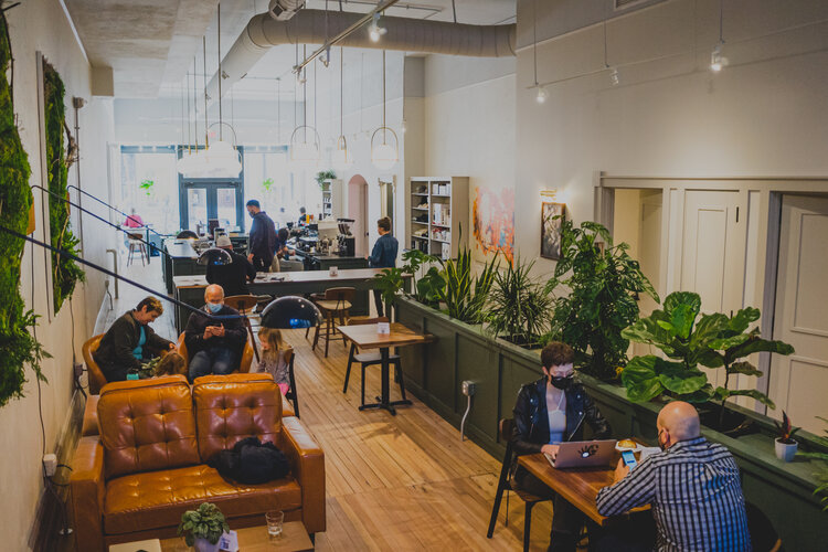 people enjoying a coffee and working at Deeper Roots Cafe