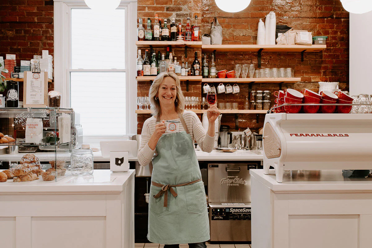 lady holding a drink in the cafe